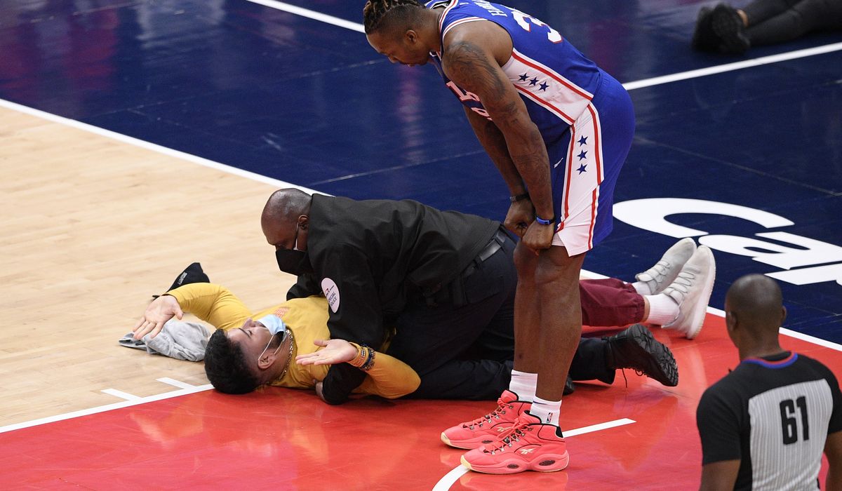 Fan runs onto court at Capital One Arena during Wizards-76ers game