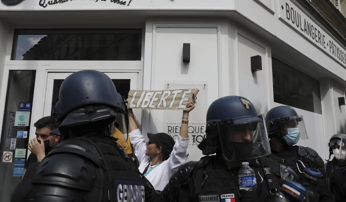 French police clash with anti-virus pass protesters in Paris