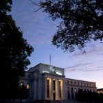 Fed announces new curbs on trading by central bank officials following criticism of ethics rules.