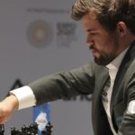 Magnus Carlsen takes lead in chess title fight with epic 136-move win