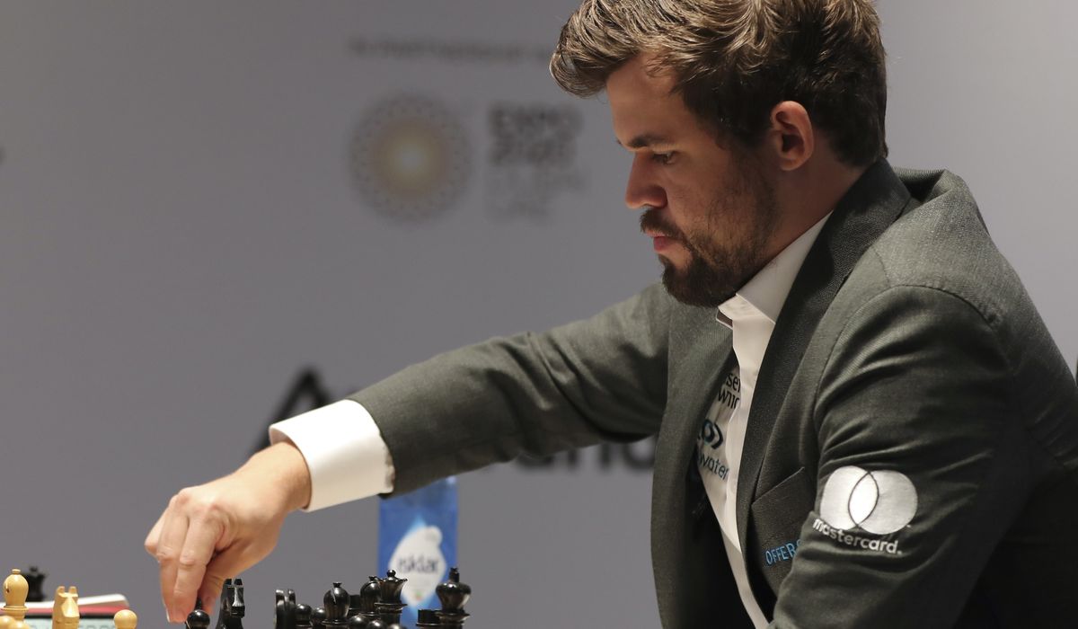 Magnus Carlsen takes lead in chess title fight with epic 136-move win