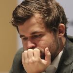 Quiet draw leaves champion Magnus Carlsen just 1 point from victory in world chess title match