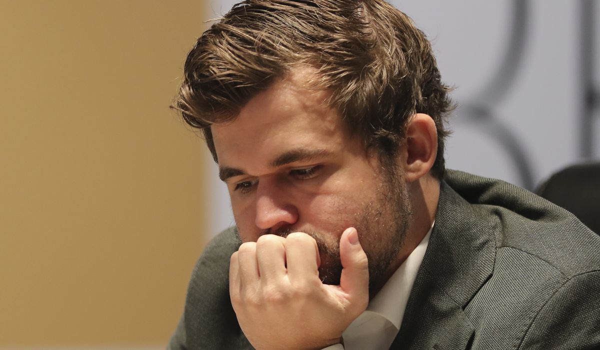 Quiet draw leaves champion Magnus Carlsen just 1 point from victory in world chess title match